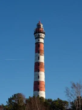 Lighthouse on a blue background Stock Photos