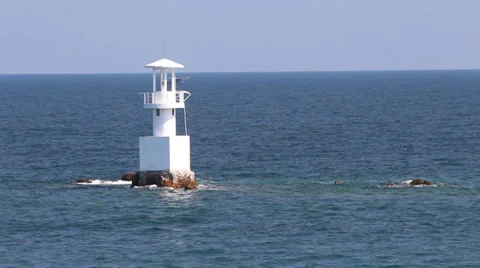 Lighthouse in the blue ocean with blue sky Stock Footage 32786032
