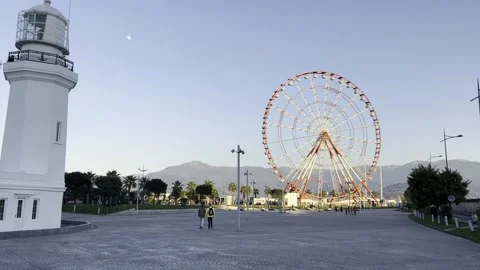 Lighthouse on the boulevard and big Ferris wheel in Batumi, Adjaria, Georgia. Stock Footage 229529973