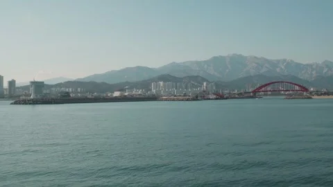 Lighthouse, bridge and mountain in Seaside town. South Korea Stock Footage 259955448