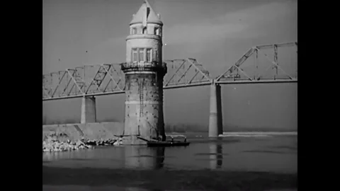 A lighthouse, a bridge, a train and operations at a water reservoir and Stock Footage 89543784