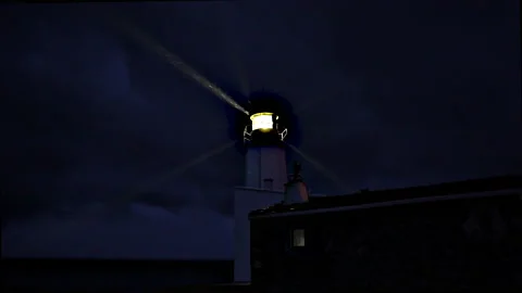 Lighthouse burning at dusk. Lighthouse light in rainy weather. 動画素材 228850794