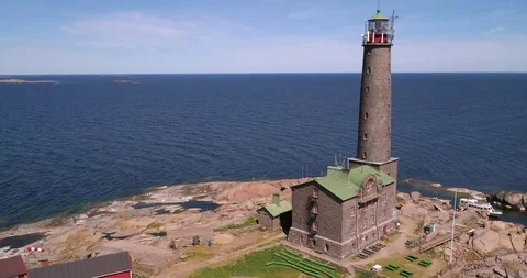 Lighthouse, C4K aerial drone view around a tall lighthouse on a rocky island  Stock Footage 94250165