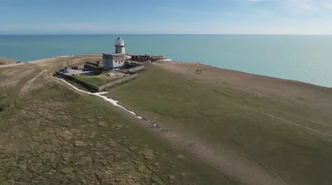 A lighthouse on a cliff area by the sea Stock Footage 67419192