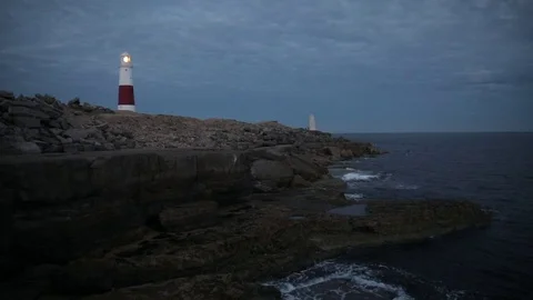 Lighthouse on the cliff at night in England Stock Footage 79787160