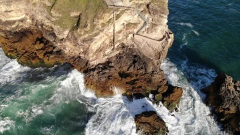 Lighthouse on a cliff rock with giant waves. ocean or sea. Aerial drone view. Stock Footage 247501788