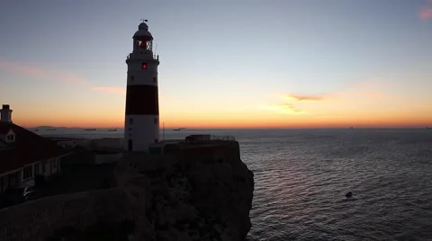 Lighthouse on a cliff at sunrise Stock Footage 52953771