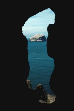 Lighthouse on a cliff. View through the opening of an old ruined castle. Bass Stock Photos