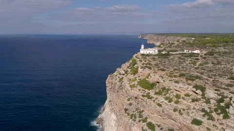 Lighthouse on the Cliffs: A Breathtaking Aerial View Stock Footage 236103343