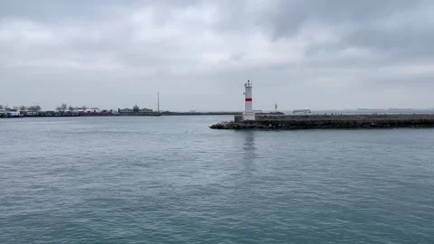 Lighthouse in a cloudy harbor Stock Footage 240325642