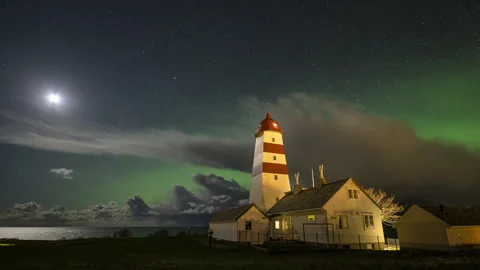 Lighthouse with cloudy sky and Aurora Borealis Stock Footage 250758705