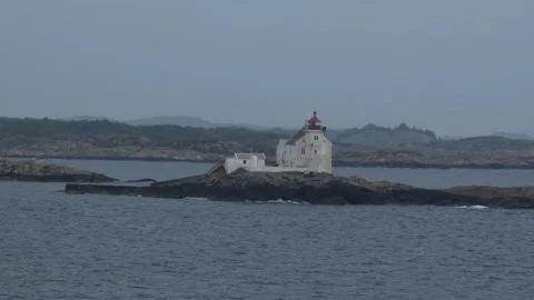 Lighthouse off the coast from ferry Stock Footage 231604654