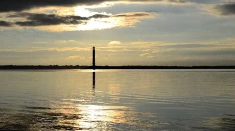 Lighthouse at dawn or sunrise with dramatic clouds Stock Footage 62512942