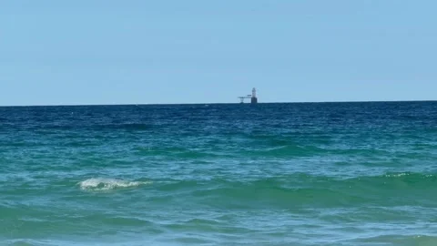 A lighthouse in the distance near Simonstown on the False Bay coastline. 库存影片 332953630