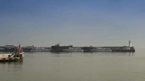 A lighthouse is in the distance at the seaside Stock Footage 35184526