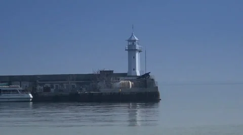 A lighthouse is in the distance at the seaside Video stock 35184527