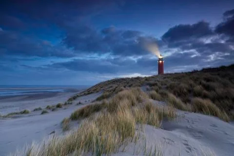 Lighthouse on dune in dusk Stock Photos