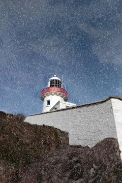 Lighthouse during a rain storm Stock Photos