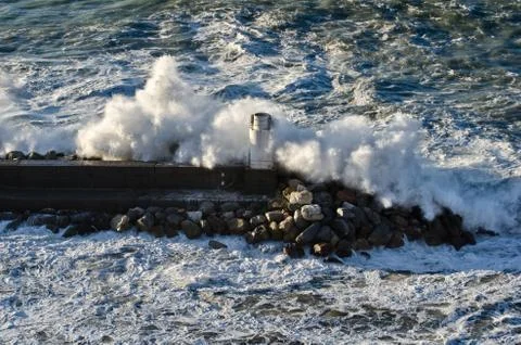 Lighthouse during a sea storm Stock Photos