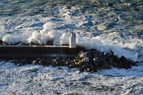 Lighthouse during a sea storm Stock Photos