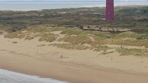 Lighthouse on Dutch dunes at Ouddorp viewed from above, Netherlands Stock Footage 315864210