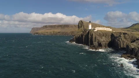Lighthouse on the edge of cliff . Neist Point, Skye drone aerial 4K Stock Footage 104579838