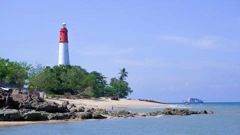 Lighthouse On The Edge Of A Tropical Beach With Large Rocks Stock Photos