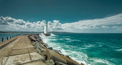Lighthouse at the end of the pier Stock Photos