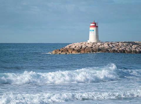 Lighthouse at the end of a pier Stock Photos