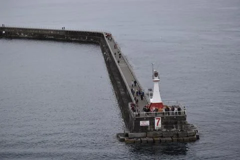 Lighthouse at the end of a pier Foto stock
