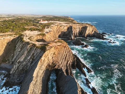 Lighthouse Farol do Cabo Sardo during the golden hour in Alentejo region Foto stock