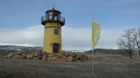 Lighthouse with flag waving in wind 9874 스톡 동영상 10837649