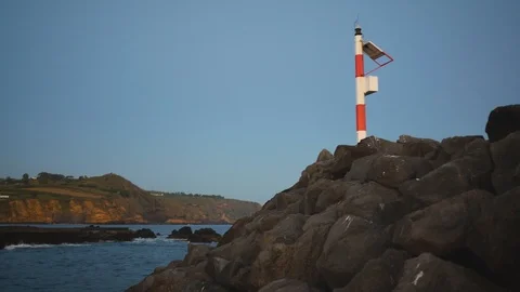 Lighthouse flashes on the ocean shore in the evening Stock Footage 94747565