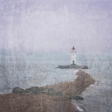 Lighthouse on foreland Stock Photos