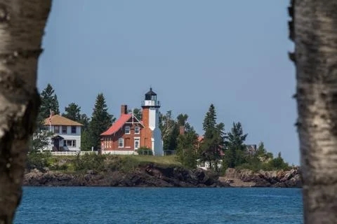 Lighthouse - framed by birch trees Stock Photos