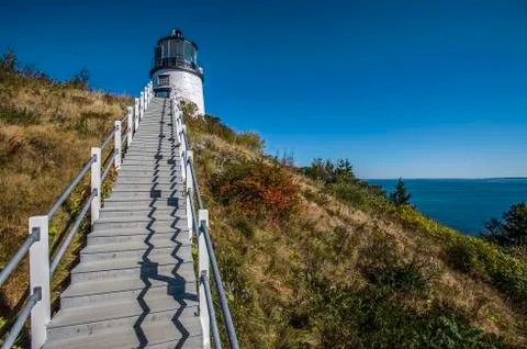 Lighthouse on a green hill with steps Stock Photos