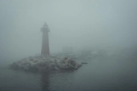Lighthouse in the harbor. Stock Photos