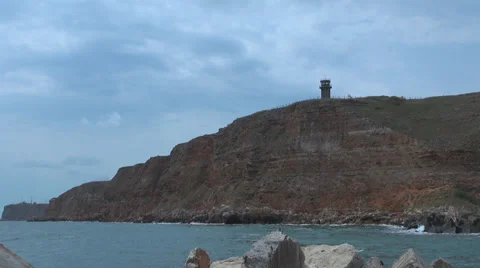 Lighthouse harbour coastline cliff navigation  rough postcard ocean sea coast  Stock Footage 32929413