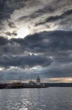 Lighthouse with heavy clouds Stock Photos