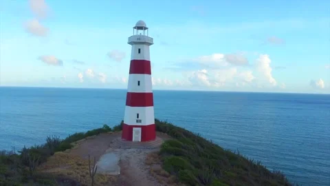 A lighthouse is on a hill overlooking the ocean Video stock 294042193