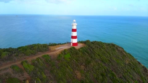 Lighthouse is on a hill overlooking the ocean Video stock 294546692