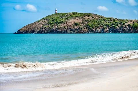 Lighthouse is on a hill overlooking the ocean Fotos Stock
