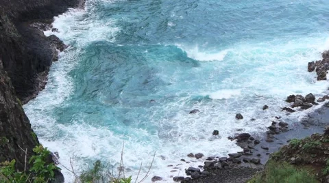 Lighthouse on a Hill Pan from Waves Below Stock Footage 1046315