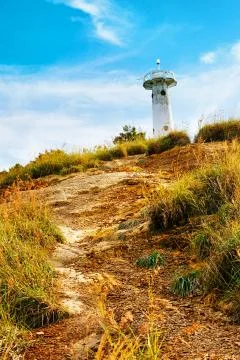 Lighthouse on a hill Stock Photos