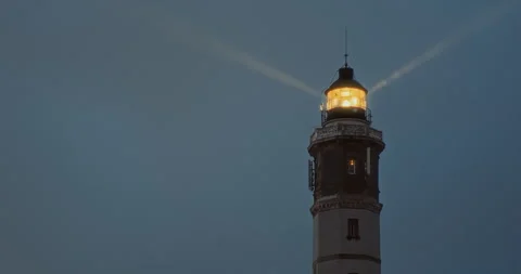 Lighthouse Illumination: The lighthouse gradually lights up, casting a warm and Vídeos de archivo 276983669