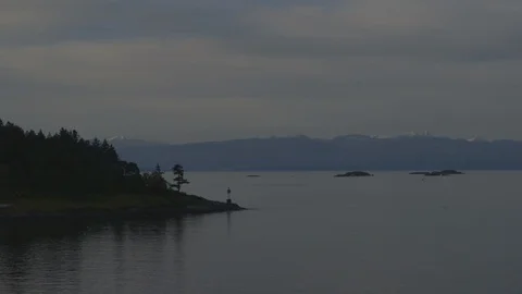 Lighthouse On Island In Front Of Landscape Background Stock-Footage 118100472