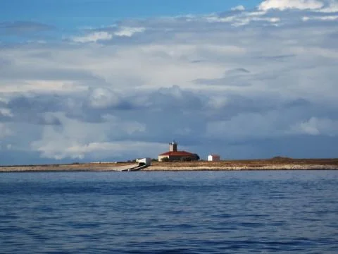 A lighthouse on the island Stock Photos