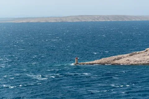 Lighthouse on island reef Stock Photos