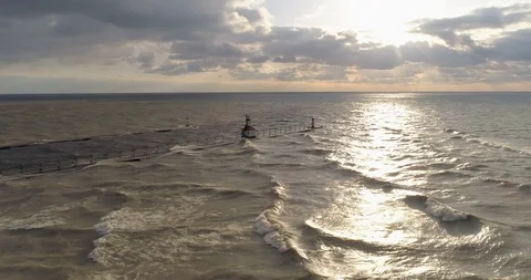 Lighthouse lake michigan with sunset pull back areial Video stock 89188103