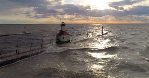 Lighthouse lake michigan with sunset pull back areial circle shot Video stock 89188211